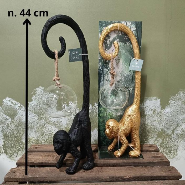 Apinateline + lasipallo, musta Musta, tukeva (muovi)apina, jonka hannassa roikkuu n. 10 halkaisijaltaan oleva lasipallo
